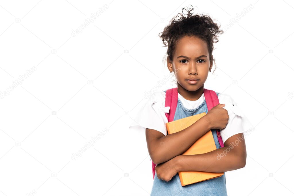 african american schoolkid looking at camera while holding book isolated on white 