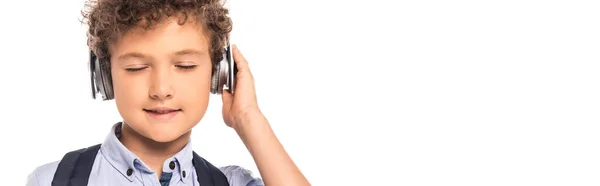 Horizontal Image Curly Schoolboy Closed Eyes Touching Wireless Headphones Isolated — Stock Photo, Image