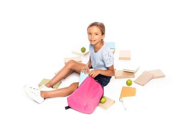 Schoolgirl Sitting Apples Putting Book Backpack Isolated White — Stock Photo, Image