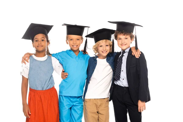 戴着毕业帽的多文化儿童身穿不同职业的服装 与白人隔离 — 图库照片