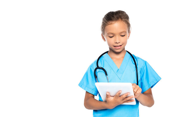 child in costume of doctor using digital tablet isolated on white 