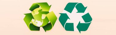 top view of green recycling symbols with planet isolated on beige, panoramic shot clipart
