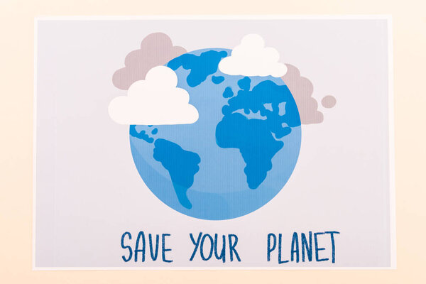 top view of placard with globe and save your planet lettering isolated on beige