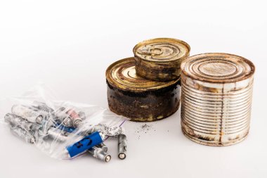 metal rusty tins and used batteries on white background clipart