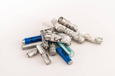 pile of used batteries on white background clipart