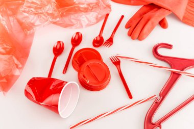 red plastic objects scattered on white background clipart