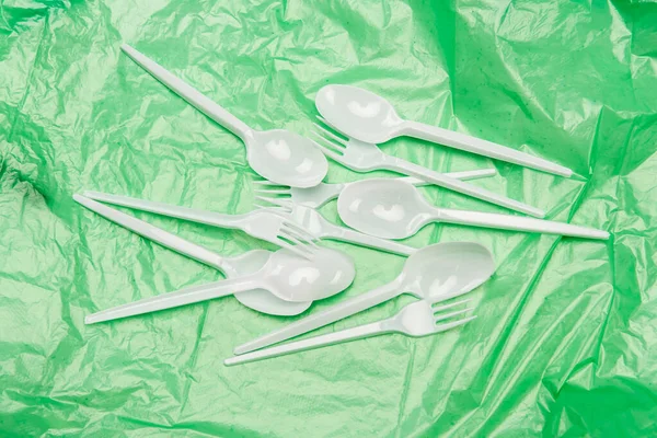 Top View White Disposable Cutlery Green Plastic Texture — Stock Photo, Image