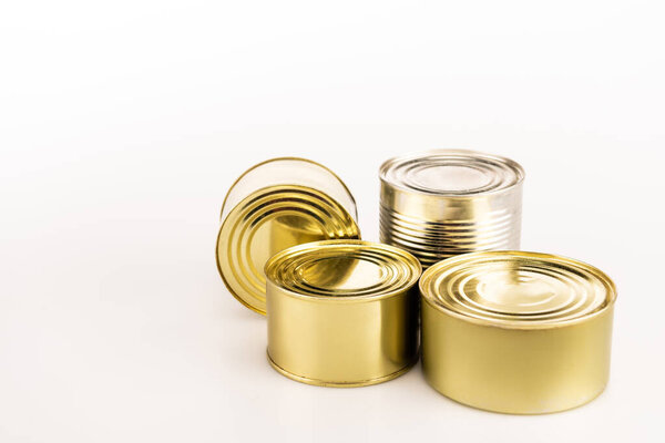 metal golden tins on white background