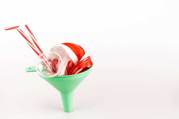 red plastic objects in funnel on white background