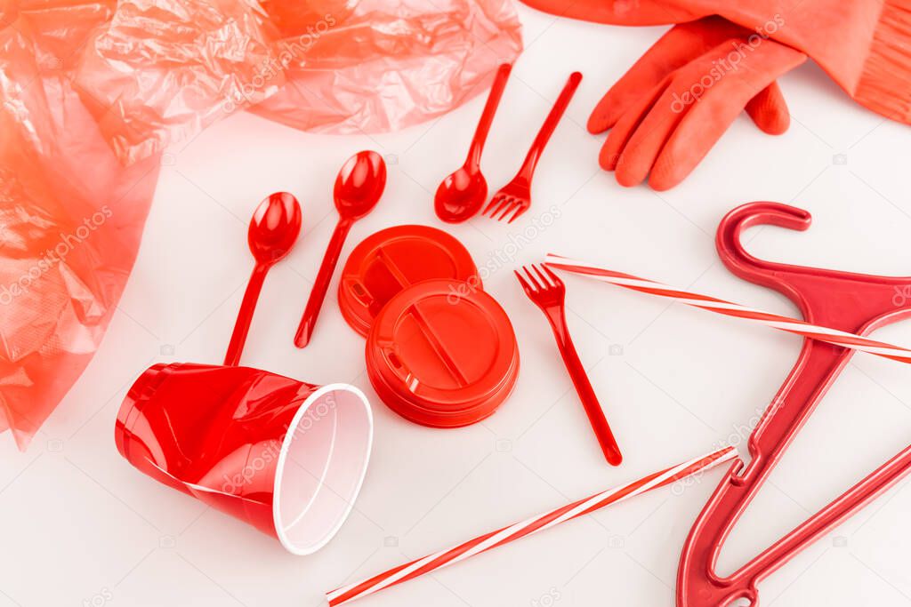 red plastic objects scattered on white background
