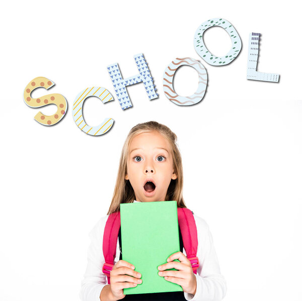 shocked schoolgirl holding book while looking at camera isolated on white, school illustration