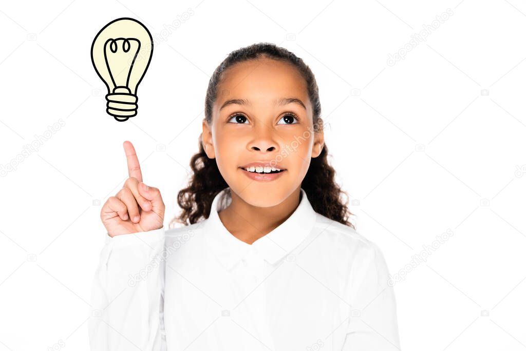 african american schoolgirl pointing at illustrated light bulb isolated on white