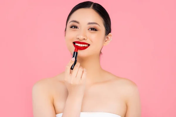 Brunette Asian Woman Applying Red Lipstick While Looking Camera Isolated — Stock Photo, Image