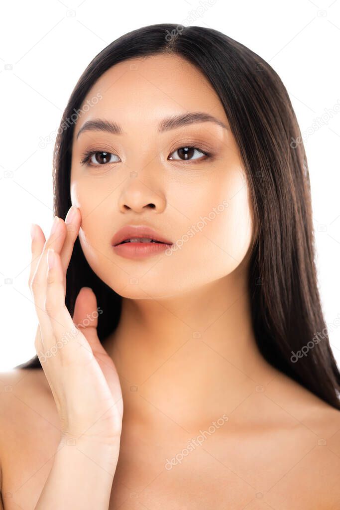 Asian woman looking away and touching face isolated on white 
