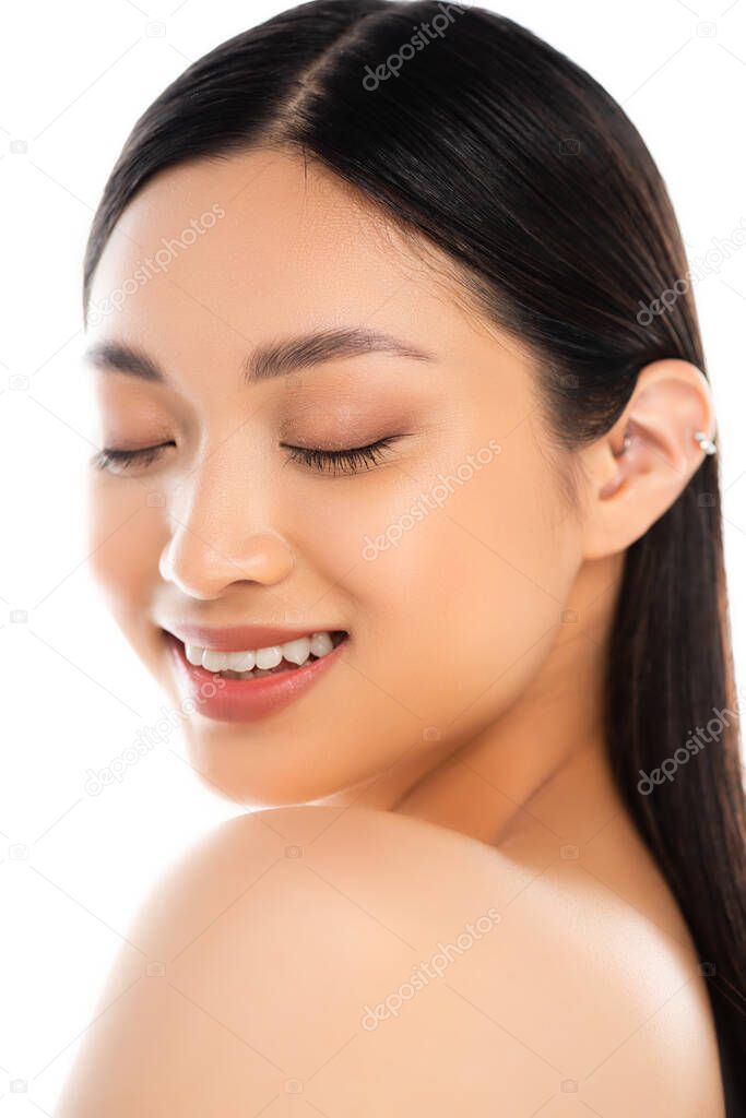 Portrait of young excited asian woman with closed eyes isolated on white