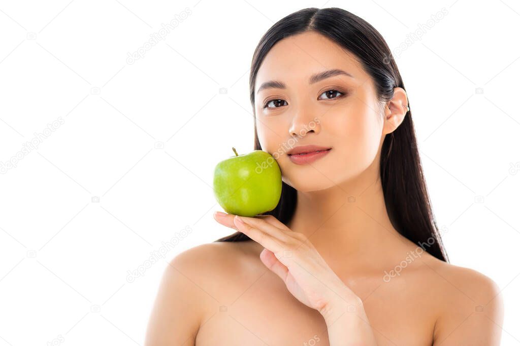 Young asian woman looking at camera and holding apple isolated on white