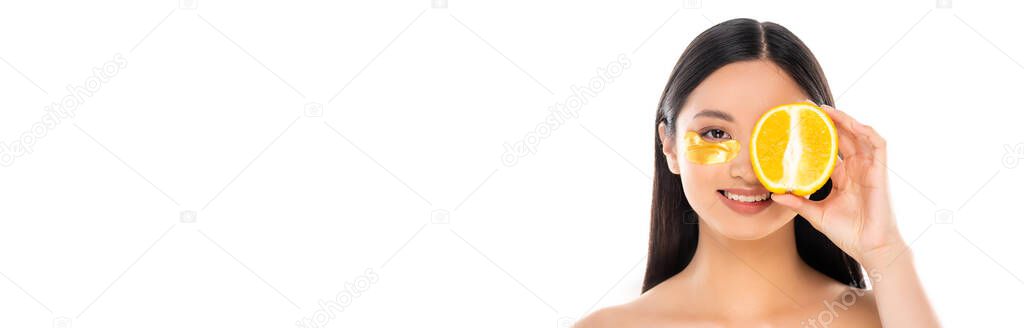 website header of asian woman with golden cosmetic patch covering eye with half of orange isolated on white