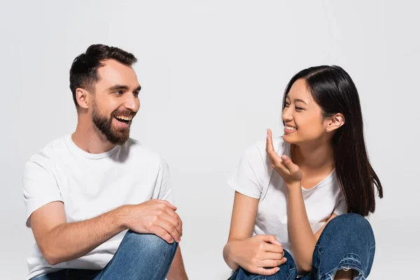 Brunette Asian Woman Holding Hand Face While Talking Bearded Man — Stock Photo, Image