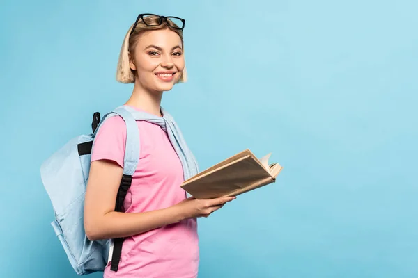 Junge Blonde Studentin Mit Rucksack Hält Buch Auf Blau Mit — Stockfoto