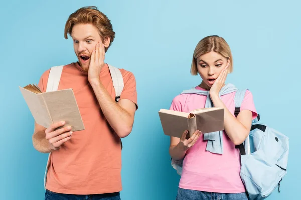 Young Shocked Students Reading Books Touching Faces Blue — Stock Photo, Image