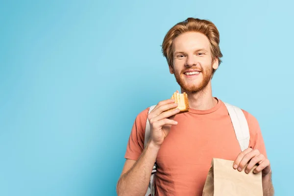 Young Redhead Student Holding Paper Bag Toast Bread Blue — Stock Photo, Image