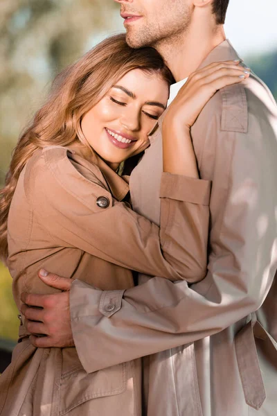 Woman Closed Eyes Hugging Man Trench Coat — Stock Photo, Image