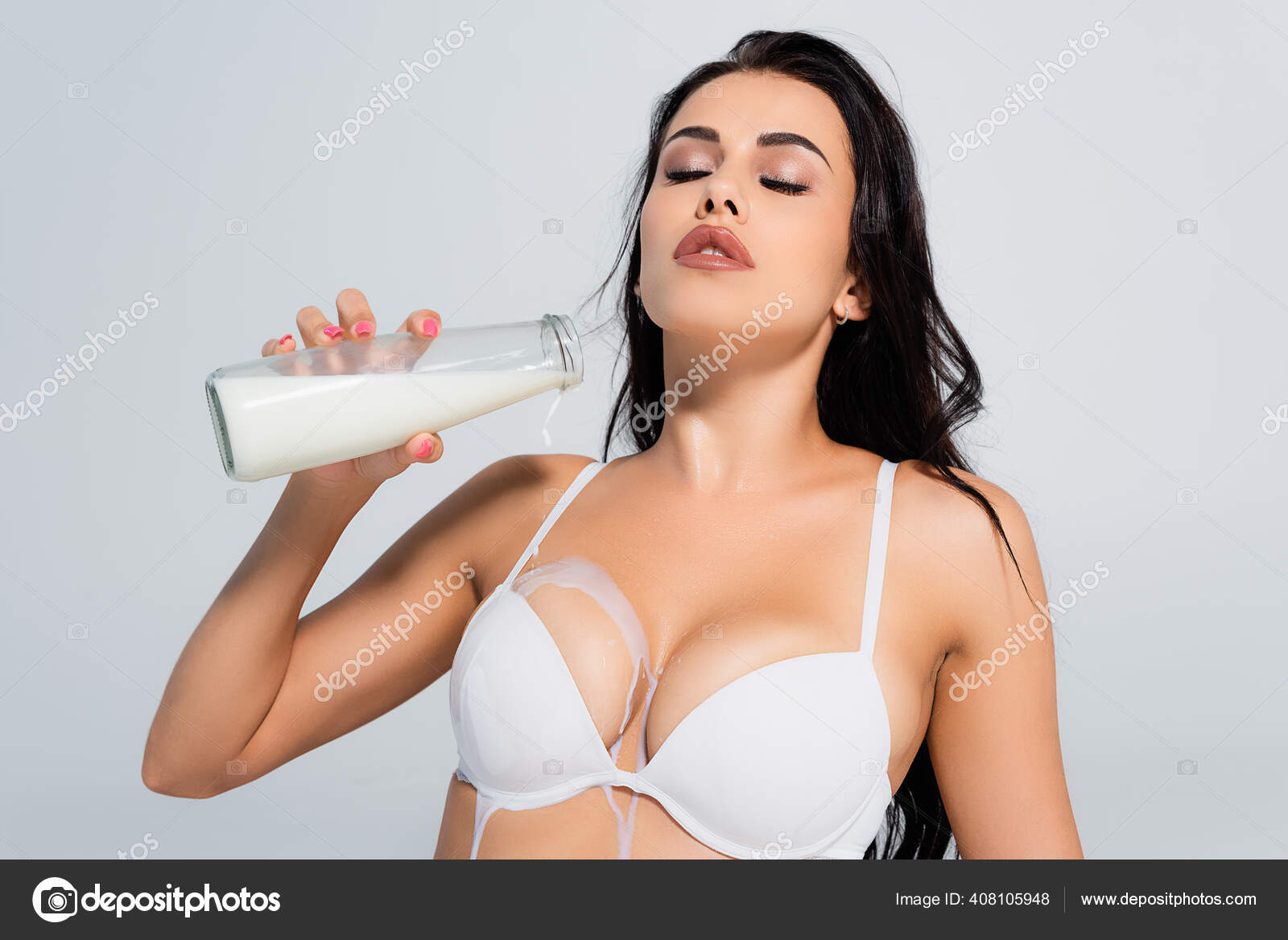 sexy woman in bra holding bottle and drinking milk isolated on grey Stock  Photo by LightFieldStudios