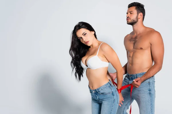 Muscular Bearded Man Tying Seductive Woman Bra White — Stock Photo, Image