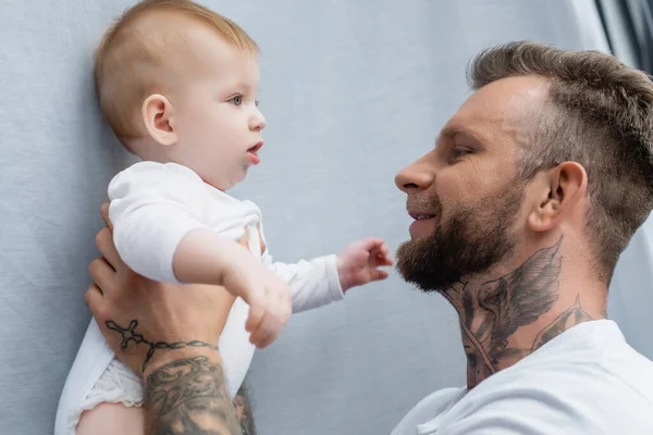 Side View Joyful Tattooed Man Holding Baby Boy Hands — Stock Photo, Image