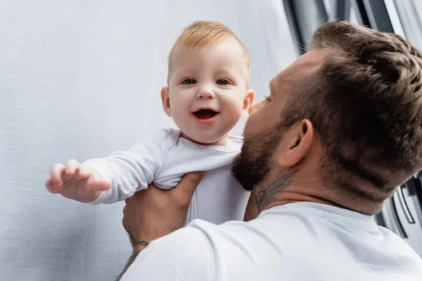 Selective Focus Young Father Holding Excited Infant Son Looking Camera — Stock Photo, Image