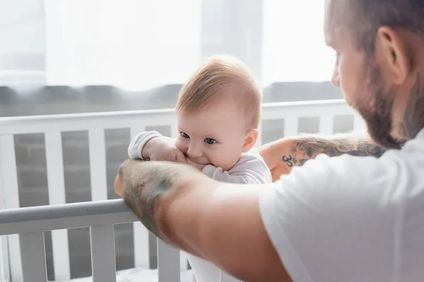 Selective Focus Young Man Supporting Baby Boy Standing Cot — Stock Photo, Image