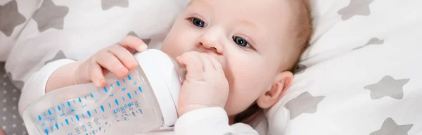 Horizontal Concept Infant Boy Holding Baby Bottle While Lying Bed — Stock Photo, Image