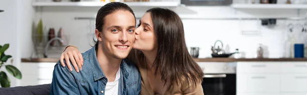 Panoramic Orientation Brunette Woman Kissing Pleased Boyfriend Looking Camera Kitchen — Stock Photo, Image