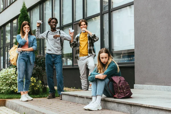 Selective Focus Upset Girl Smiling Multicultural Teenagers Clumped Paper Outdoors — Stock Photo, Image