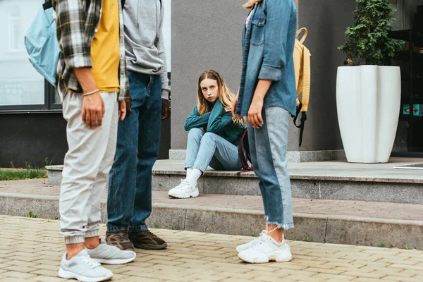 Selective Focus Sad Girl Looking Multiethnic Teenagers Backpacks Outdoors — Stock Photo, Image