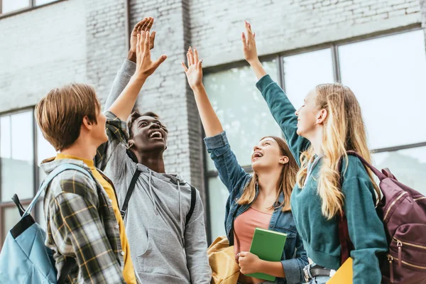 Selective Focus Positive Multicultural Teenagers Backpacks Raised Hands Outdoors — Stock Photo, Image
