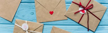top view of wooden blue background with envelopes and hearts, panoramic shot clipart