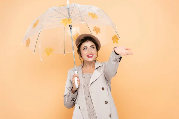 Joyful Woman Outstretched Hand Umbrella Decorated Yellow Leaves Peach — Stock Photo, Image