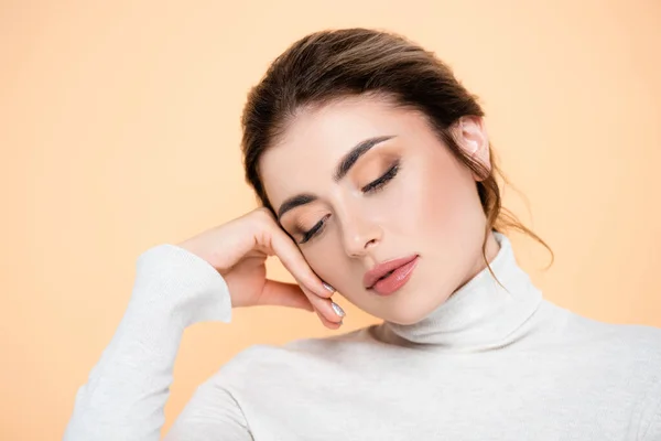 Young Woman Turtleneck Touching Face While Posing Isolated Peach — Stock Photo, Image