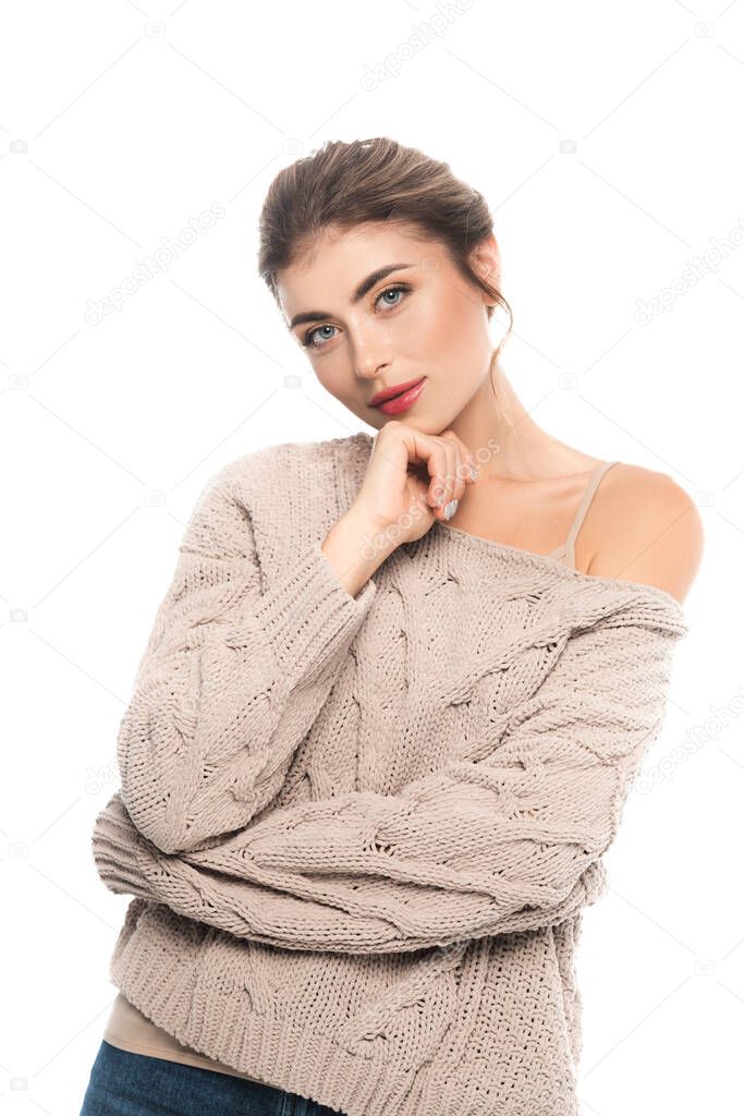 stylish woman in openwork sweater looking at camera isolated on white