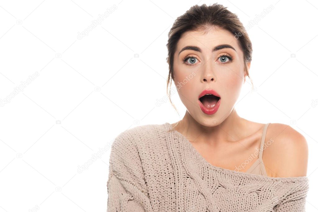shocked woman in trendy sweater looking at camera with open mouth isolated on white