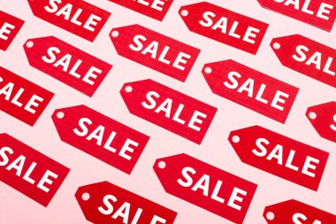 top view of labels with sale lettering on pink, black friday concept clipart