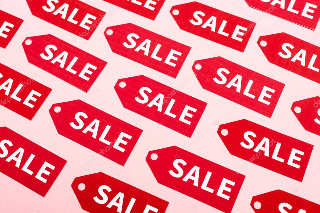 top view of labels with sale lettering on pink, black friday concept