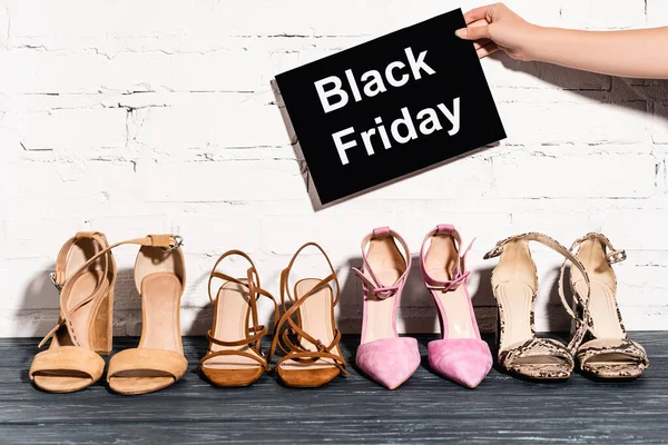 Cropped View Woman Holding Placard Black Friday Lettering Shoes Brick — Stock Photo, Image