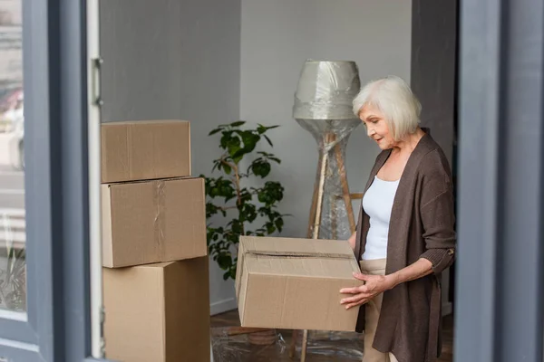 Cheerful Senior Woman Holding Cardboard Box Moving Concept — Stock Photo, Image