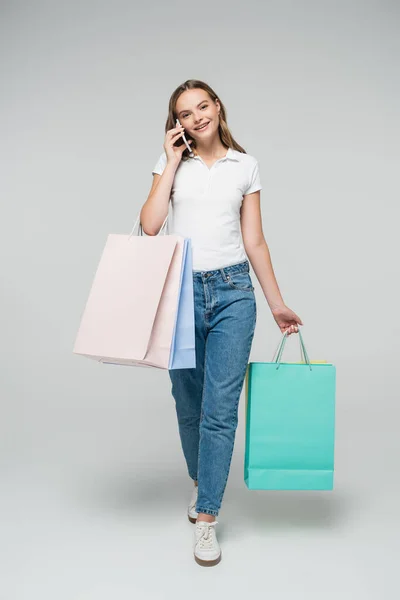 Joyful Woman Talking Smartphone Holding Shopping Bags Grey — Stock Photo, Image