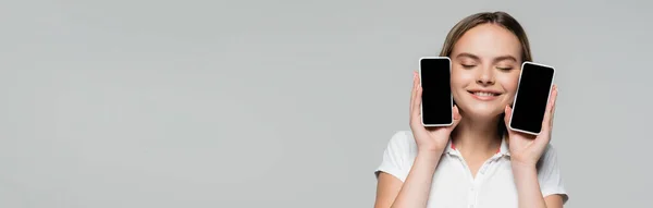 一个横向的概念 就是快乐的女人拿着用灰色黑色星期五的概念隔离的空白屏幕智能手机 — 图库照片