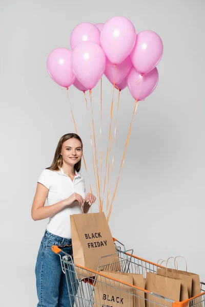 Young Joyful Woman Holding Shopping Bag Black Friday Lettering Cart — Stock Photo, Image