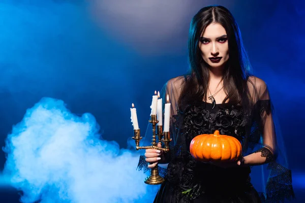 Young Pale Woman Scary Makeup Holding Pumpkin Burning Candles Blue — Stock Photo, Image