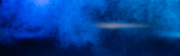 panoramic crop of dark blue background with smoke and copy space
